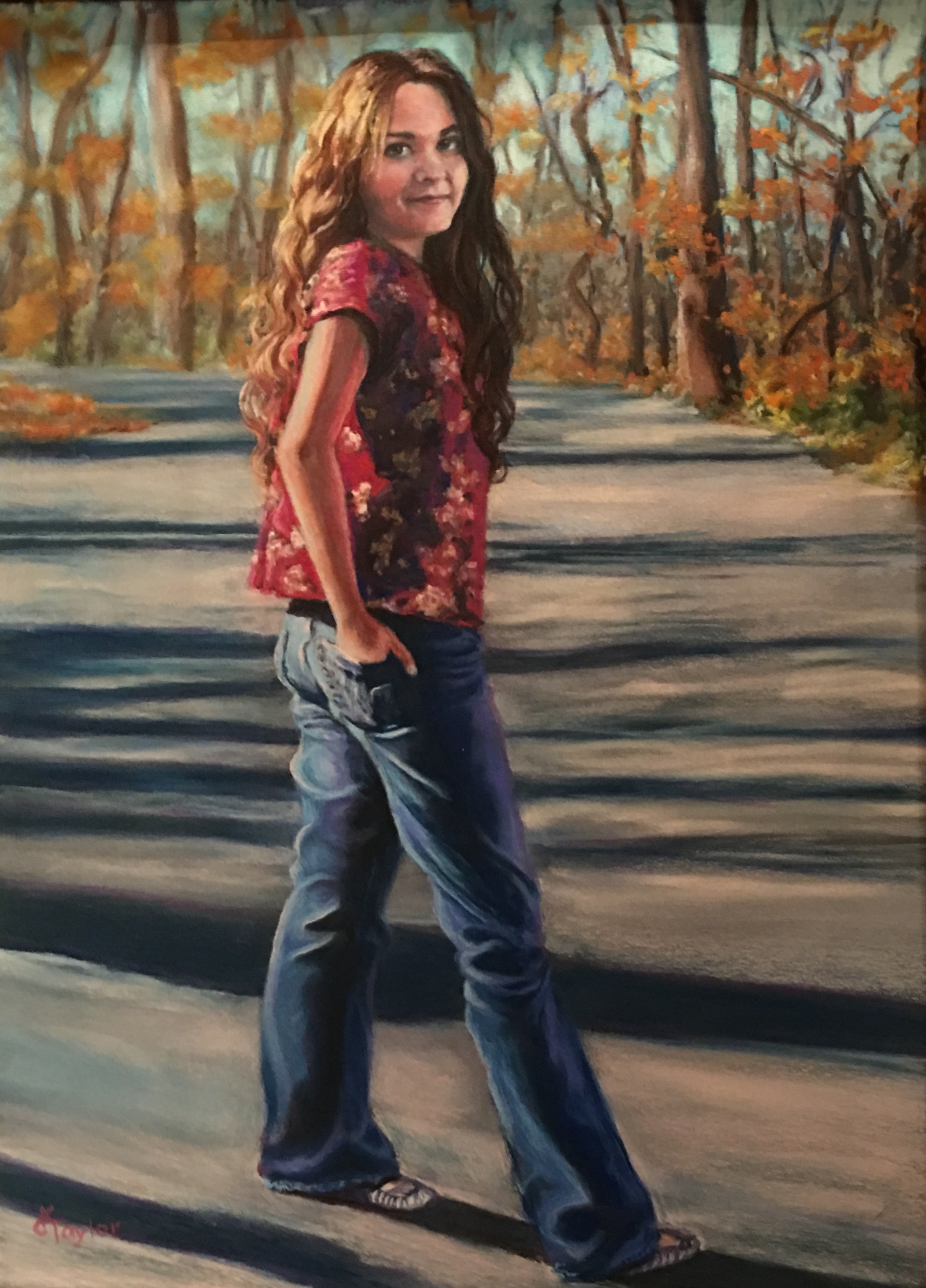 Young woman on autumn path looking back at camera