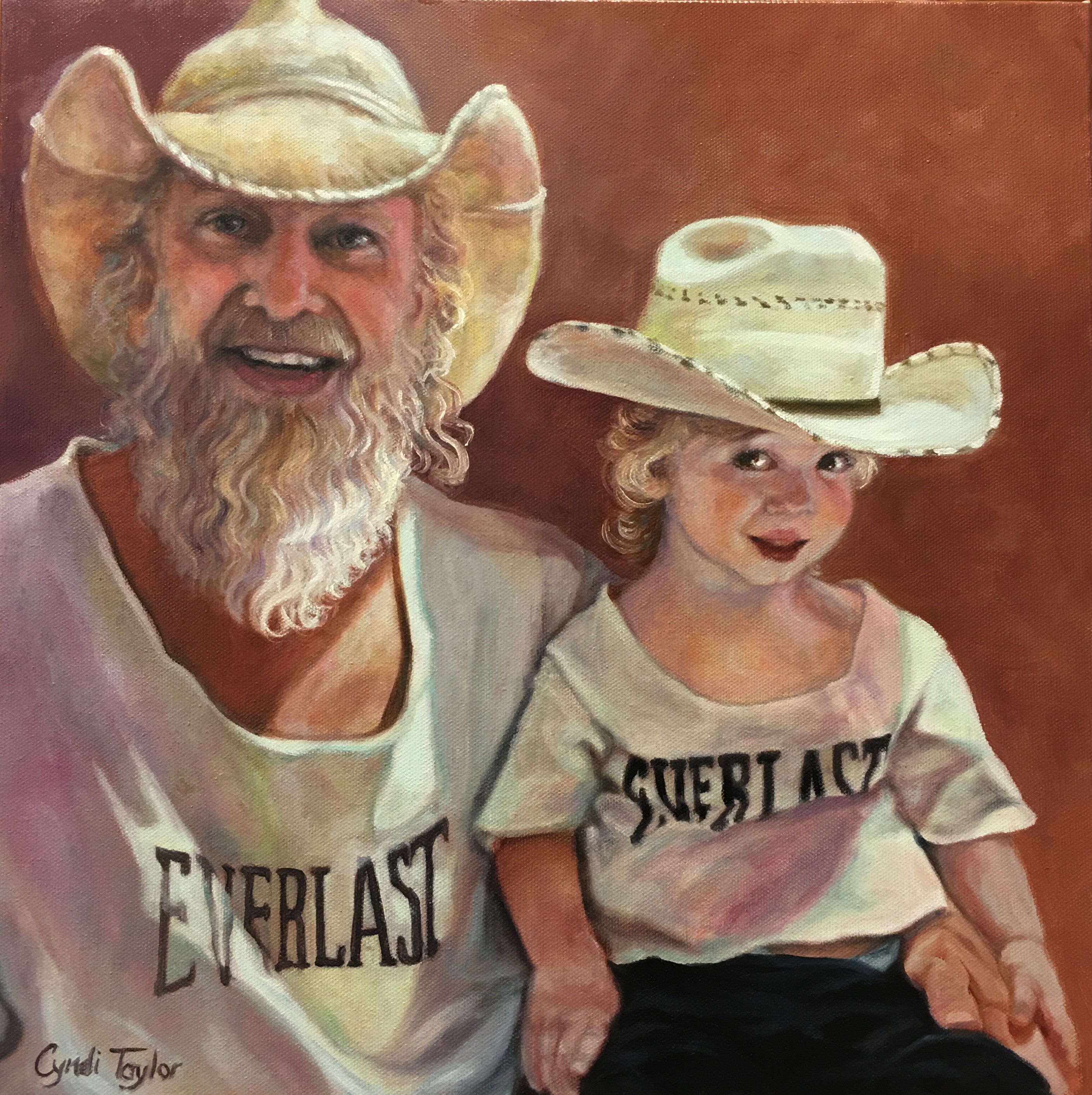 Bearded man and young boy wearing cowboy hats and matching Everlast shirts
